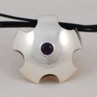 Scalloped silver pendant set with amethyst